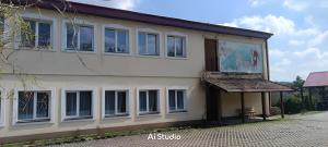 a building with white windows on the side of it at Agroturystyka pod Chyrową in Chyrowa