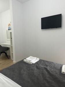 a white room with a flat screen tv on a wall at Sfara Residence Apartament 6 in Baia Mare +16 photos