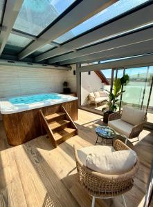 a large jacuzzi tub in a room with a table and chairs at Hotel U Kata in Kutná Hora