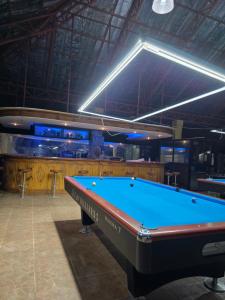a pool table in a room with a bar at Gilkrissa Garden in San Nicolas +42 photos