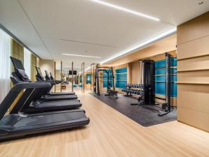 a gym with treadmills and elliptical machines at Canton Hotel Guangzhou, Tapestry Collection By Hilton in Guangzhou