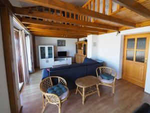 a living room with a blue couch and chairs at Apartman Seven Waves in Punat