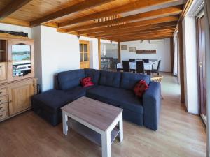 a living room with a blue couch and a table at Apartman Seven Waves in Punat