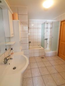 a bathroom with a sink and a shower at Apartman Seven Waves in Punat +27 photos