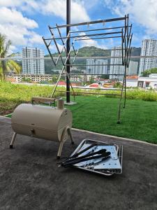 a grill and a pile of tools on the ground at Penang Gelugor Landed House 4Rooms 3 Bathrooms in Gelugor