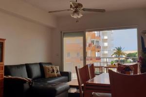 a living room with a couch and a table at Mediterranean Apartment with WIFI in Canet de Berenguer