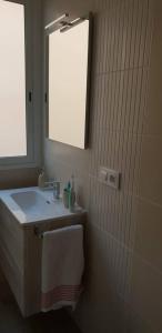 a bathroom with a sink and a mirror at Mediterranean Apartment with WIFI in Canet de Berenguer +16 photos