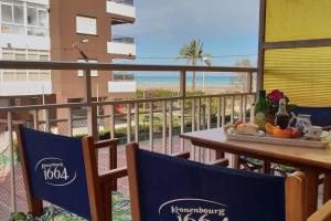 a balcony with a table and chairs with a view of the beach at Mediterranean Apartment with WIFI in Canet de Berenguer