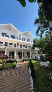 a large white building with stairs in front of it at ClubBoracay Apartelle in Boracay