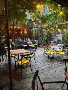 a patio with tables and chairs in a restaurant at Bed and Breakfast "Caffe-caffe" in Kikinda