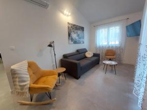 a living room with a couch and a chair at Apartmani 3T in Blace