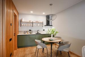 a kitchen with a table and chairs in a kitchen at Albatross Home in Ķesterciems