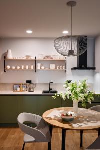 a kitchen with a table and two chairs and a table at Albatross Home in Ķesterciems +17 photos