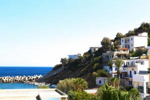 a view of a beach with white buildings and the ocean at stamatia's rooms in Agios Kirykos