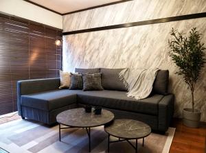 a living room with a couch and two tables at #52 Towny Yanagihara in Numazu