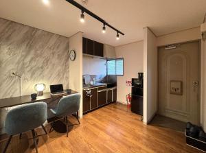 a kitchen with a desk with chairs and a laptop at #52 Towny Yanagihara in Numazu