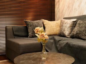a vase with flowers on a table in front of a couch at #52 Towny Yanagihara in Numazu +28 photos