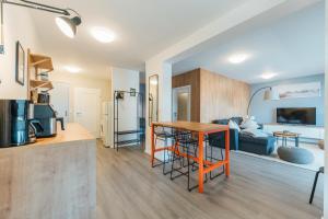 a kitchen and living room with a table in a room at Deich 71 in Borkum