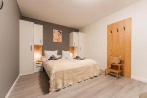 a bedroom with a bed and a cabinet and a chair at Deich 71 in Borkum