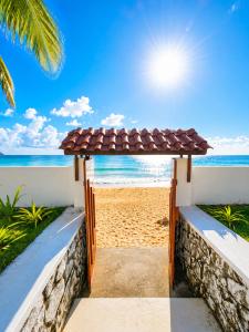 a gate to the beach with the ocean in the background at Dutch Bay Villa - Trincomalee in Trincomalee