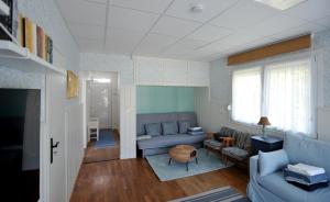 a living room with a couch and a table at LelleBlue Vendégház in Balatonlelle