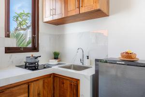 a kitchen with a sink and a dishwasher at Cove Tegeh Bila in Ungasan