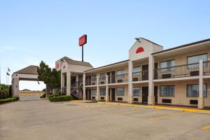 an empty parking lot in front of a hotel at Ramada by Wyndham San Antonio Near SeaWorld - Lackland AFB in San Antonio