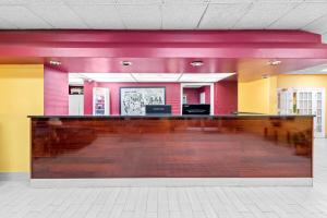 a lobby with a bar in the middle of a room at Super 8 by Wyndham Gaffney in Gaffney