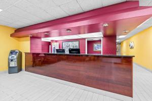 a bar in a hospital lobby with pink walls at Super 8 by Wyndham Gaffney in Gaffney