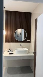 a bathroom with a sink and a mirror at ภัสรา รีสอร์ท in Ban Nong Khla +11 photos
