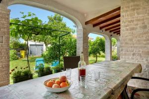 an outdoor table with a bowl of oranges on it at Anka in Medulin * Istrien in Medulin