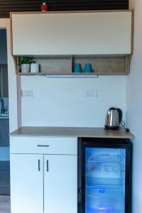 a microwave oven sitting under a counter in a kitchen at Velen Harmony- בקתות מושלמות עם בריכה במתחם in ‘Ein el Asad +19 photos