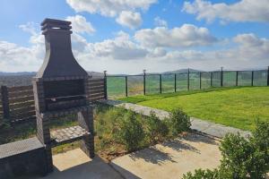a statue of a fire hydrant next to a field at Velen Harmony- בקתות מושלמות עם בריכה במתחם in ‘Ein el Asad