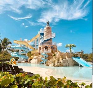 a water park at the resort with a water slide at Relax at Private beach, Pools, Acuatic Park & more in Bayahibe