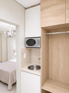 a small kitchen with a sink and a microwave at Studios Chrissi-Renovated 2026, Just 20m from the Beach in Skala Sotiros +29 photos