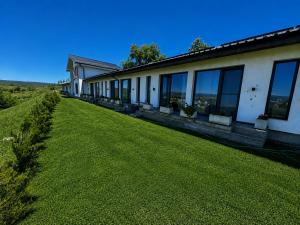 a building with a large lawn in front of it at Hill House in Drobeta-Turnu Severin