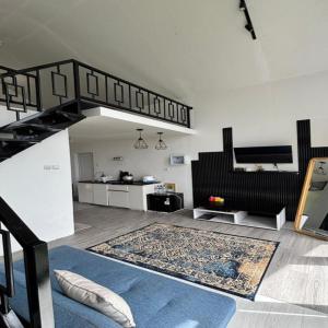 a living room with a staircase and a rug at Cabin Athenea Sikapuk in Kejajar