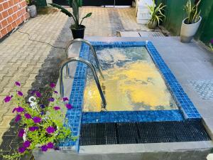 a pool of water in a blue tiled at Sun and Waves Beach Cottage Ahungalla in Ahungalla