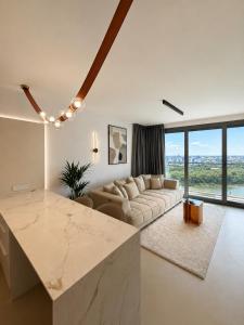 a large living room with a couch and a table at Eurovea Tower, 27th floor apartment, free parking in Bratislava