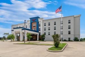 a hotel with an american flag in front of it at Hampton Inn Marion in Marion
