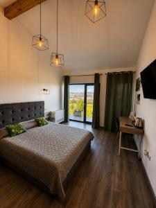 a bedroom with a bed and a table and a window at Hill House in Drobeta-Turnu Severin