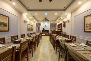 a large dining room with long tables and chairs at Binh Anh Hotel in Hanoi