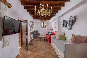 a living room with a couch and a chandelier at Casa Aestas in Lachania