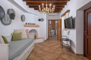 a living room with a couch and a tv at Casa Aestas in Lachania