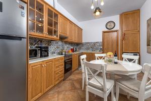a kitchen with wooden cabinets and a table and chairs at Casa Aestas in Lachania +13 photos