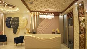 a room with a table and some masks on the wall at Thejaiparadise by jai hotel in Rohtak