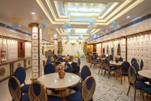 a restaurant with tables and chairs in a room at Thejaiparadise by jai hotel in Rohtak