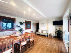 a dining room and living room with a table and chairs at Maison Balù Villa in Torri del Benaco