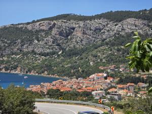 a town on the side of a mountain with a road at Apartman Mihaela in Komiža