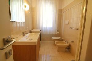 a white bathroom with a toilet and a sink at Al Numero 16 in Levanto +18 photos